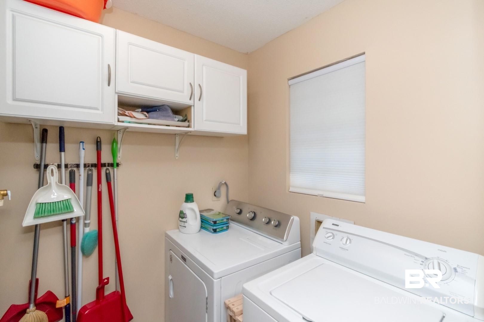 1321 Rainbow Drive West Mobile, AL 36693 - Photo 20 of 48 Laundry area with cabinets and washer and dryer