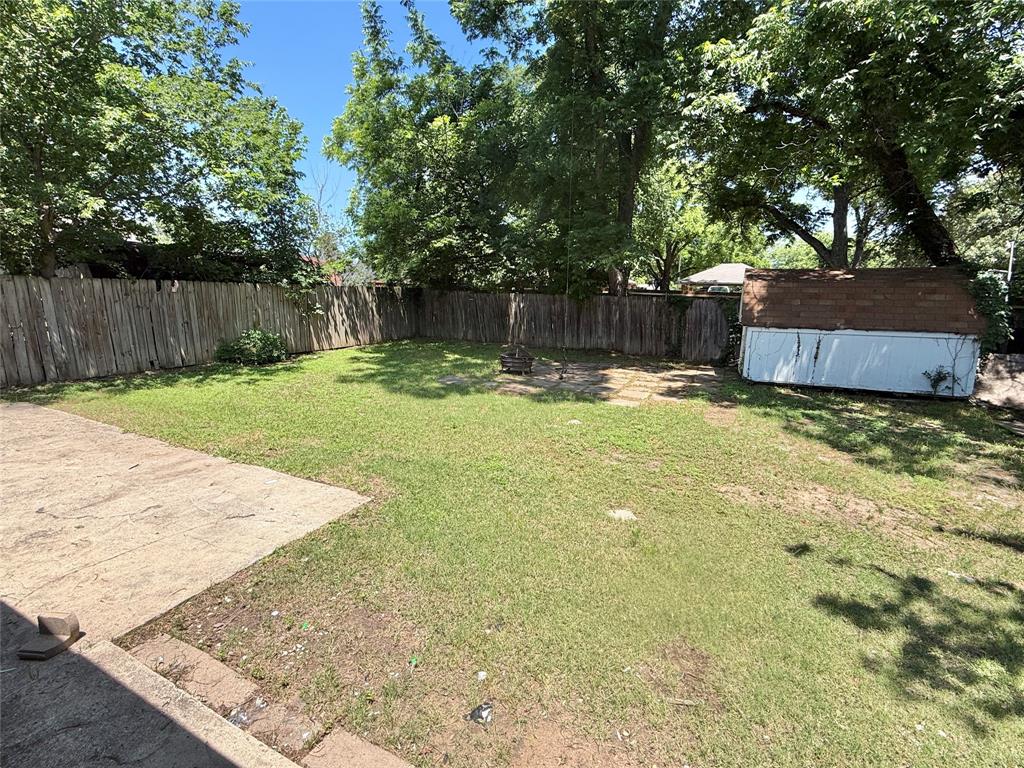 1617 East Union Bower Road Irving, TX 75061 - Photo 13 of 14 a view of a backyard with large trees and wooden fence