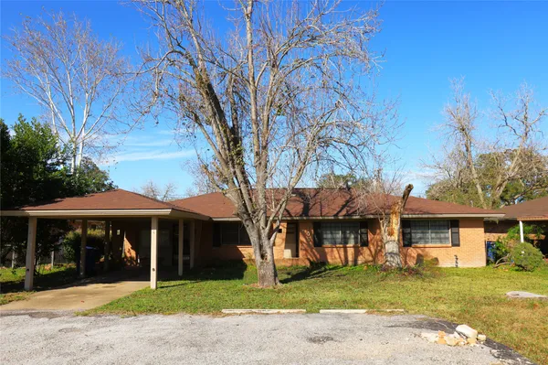 a view of a house with a yard and sitting area