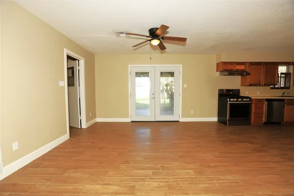 a view of a livingroom with a kitchen and a stove
