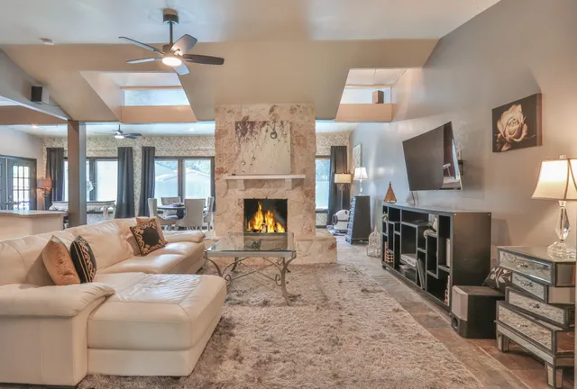 a living room with furniture flat screen tv and a fireplace
