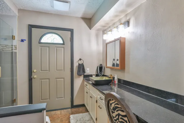 a view of bathroom with a tub mirror and window