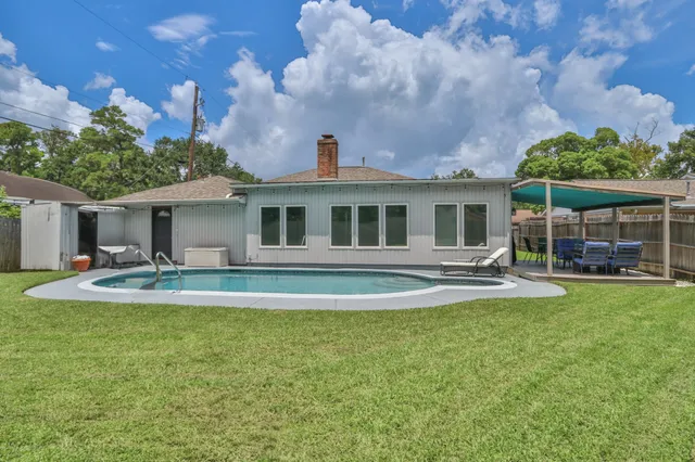 a view of house with outdoor space and swimming pool