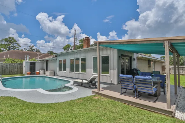 a view of a patio with couches chairs and a fire pit