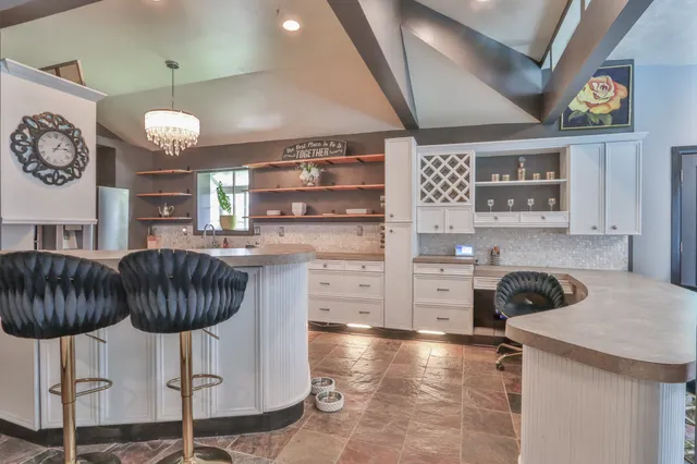 a kitchen with cabinets and chandelier
