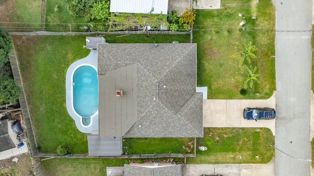an aerial view of a house with a lake