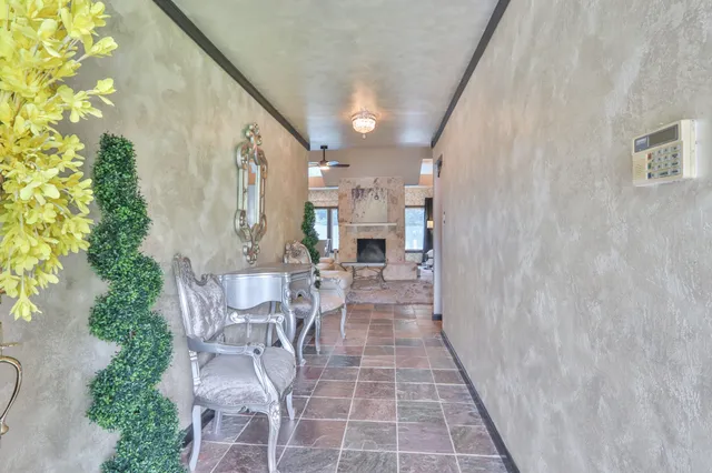 a view of a patio with couches table and chairs and potted plants