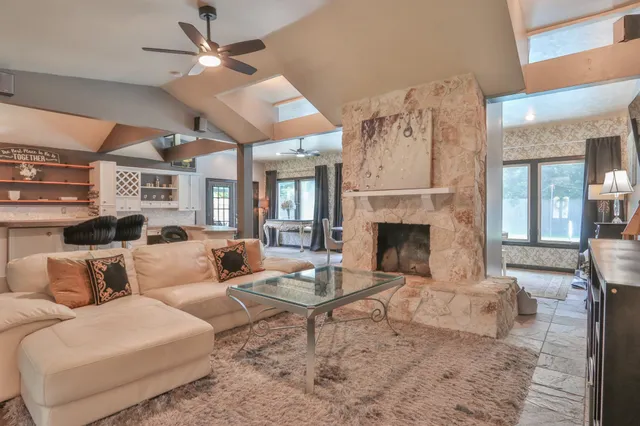 a living room with furniture flat screen tv and a fireplace