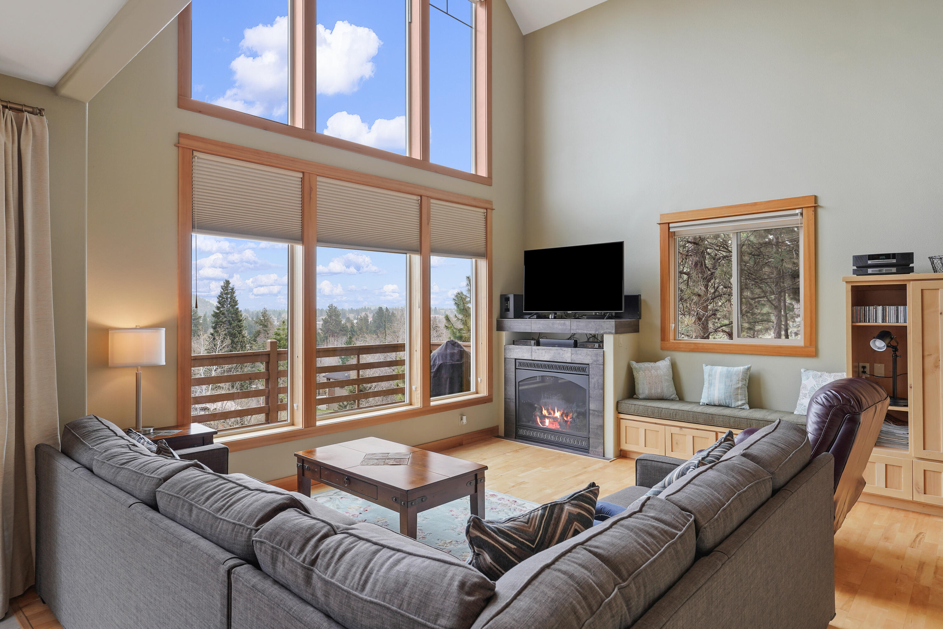 2155 Northwest Awbrey Road Bend, OR 97703 - Photo 9 of 44 a living room with furniture a flat screen tv and a large window