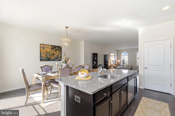a open kitchen with granite countertop breakfast area
