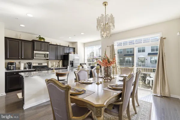a view of a dining room with furniture wooden floor and chandelier
