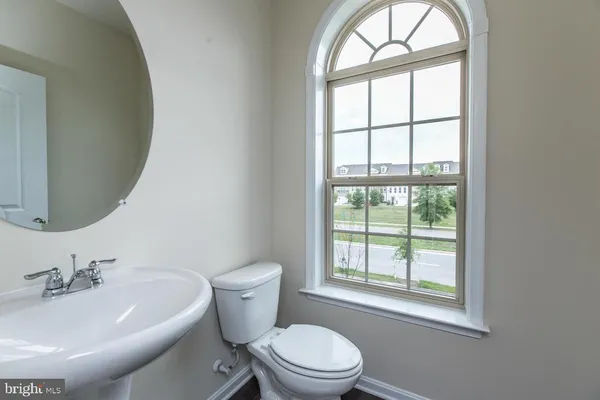 a white toilet sitting next to a bathroom sink