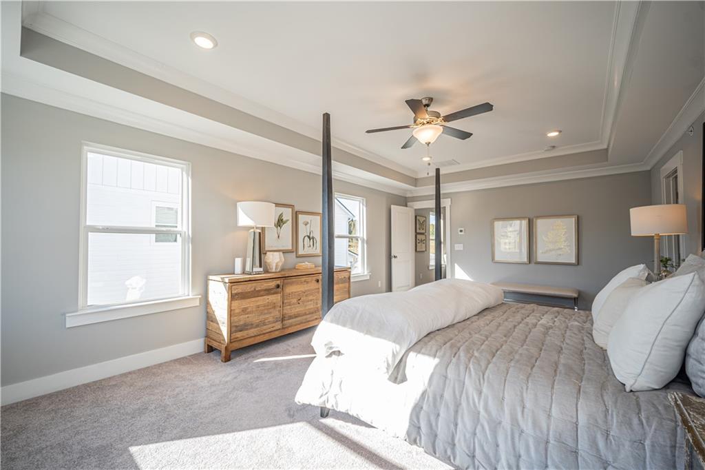 1719 Prospect Way Conyers, GA 30094 - Photo 13 of 18 a spacious bedroom with a large bed and ceiling fan
