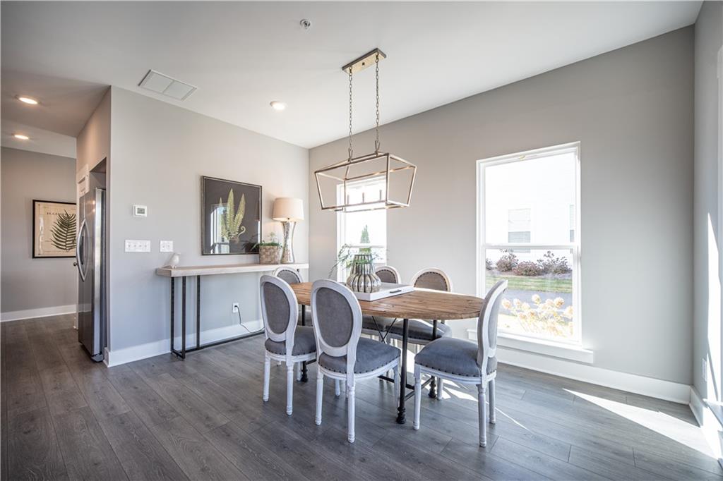 1719 Prospect Way Conyers, GA 30094 - Photo 5 of 18 a dining room with furniture a chandelier and wooden floor