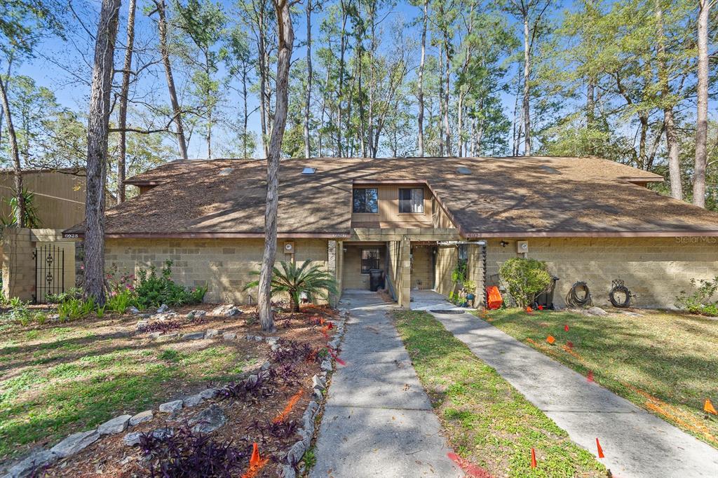 a view of a house with backyard porch and sitting area