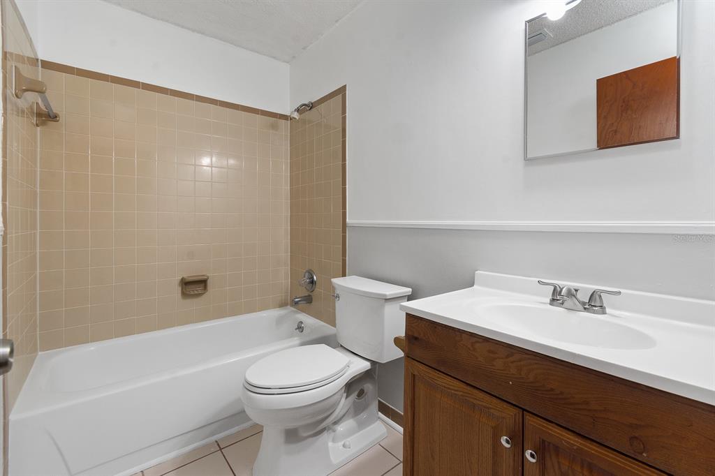 6926 Southwest 45th Avenue Gainesville, FL 32608 - Photo 16 of 28 a bathroom with a sink a toilet and shower