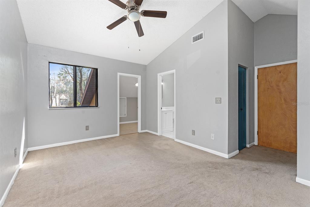 6926 Southwest 45th Avenue Gainesville, FL 32608 - Photo 18 of 28 an empty room with windows and fan