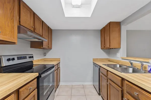 a kitchen that has a sink and a stove