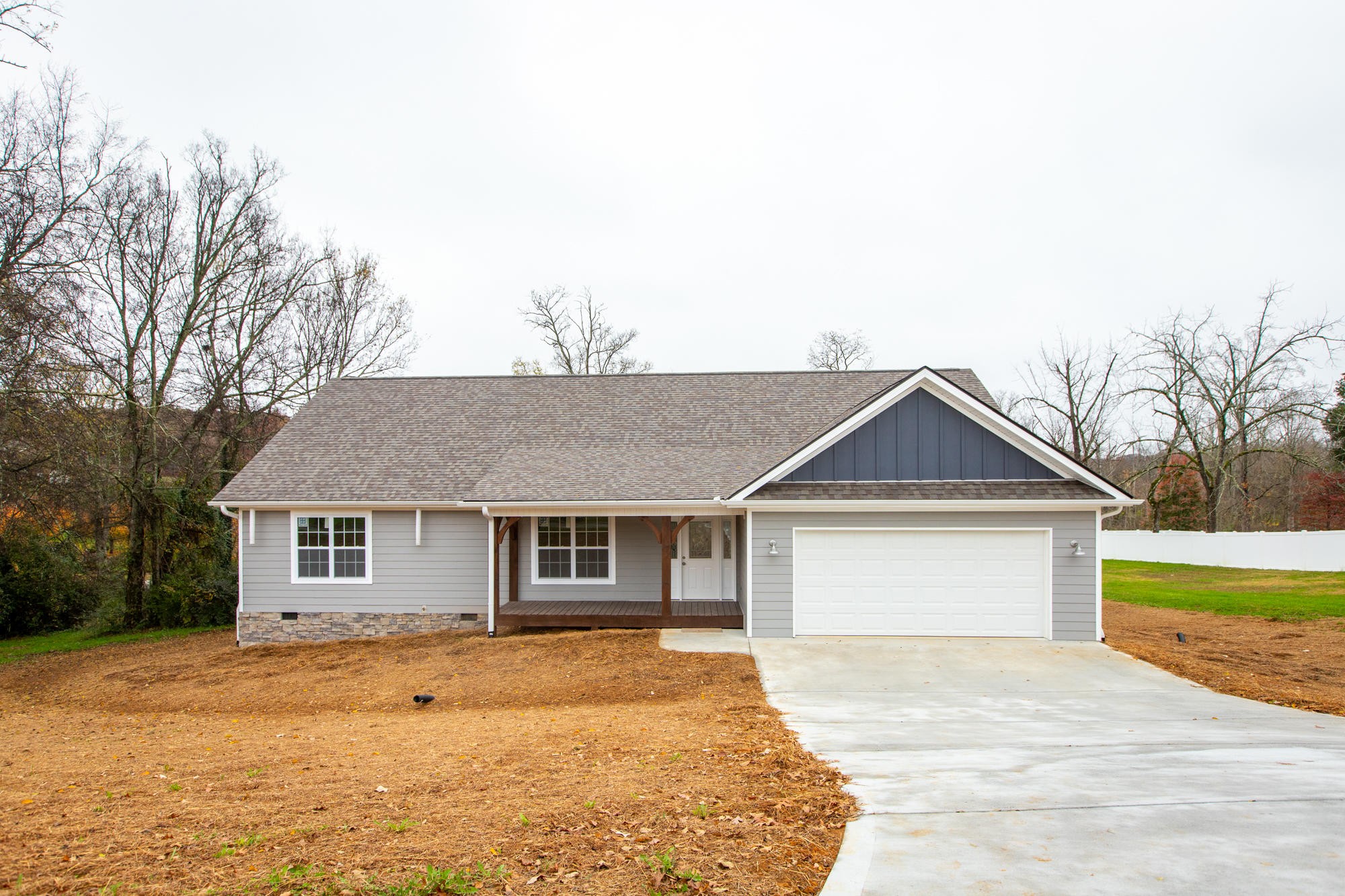 a front view of a house with a garden and yard