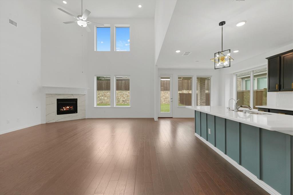 3533 Hyacinth Way Prosper, TX 75078 - Photo 10 of 38 an empty room with wooden floor and windows