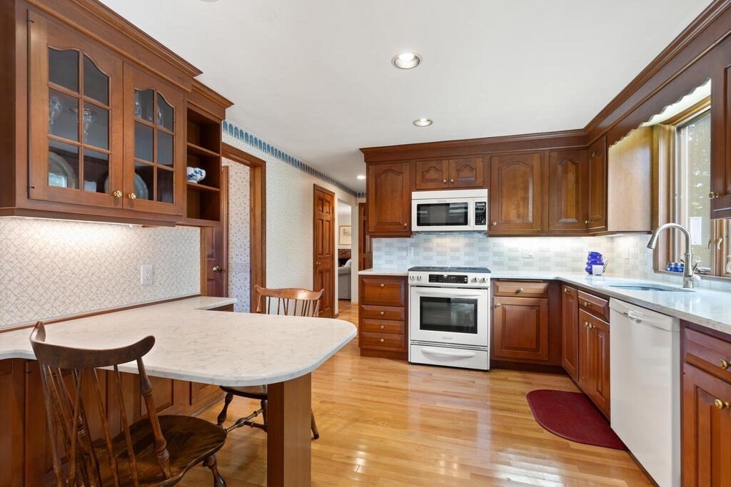 14 Parkerville Road Chelmsford, MA 01824 - Photo 11 of 34 a kitchen with stainless steel appliances granite countertop a stove top oven a sink dishwasher and cabinets with wooden floor