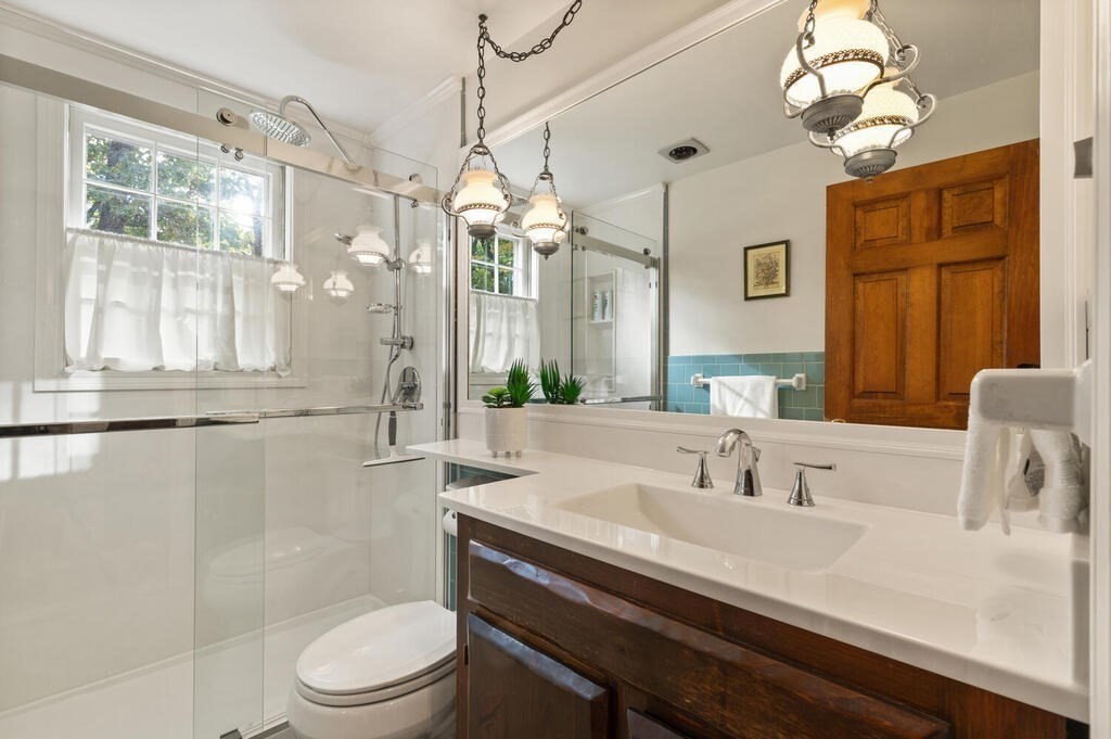 14 Parkerville Road Chelmsford, MA 01824 - Photo 19 of 34 a bathroom with a sink a toilet a mirror and shower