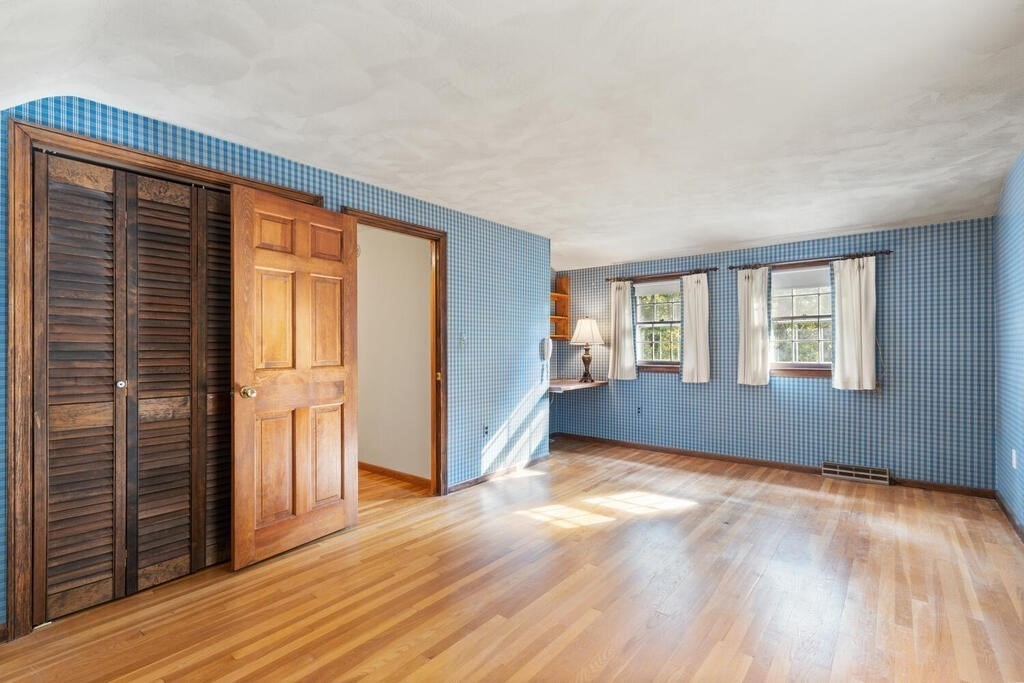 14 Parkerville Road Chelmsford, MA 01824 - Photo 22 of 34 a view of an empty room with wooden floor and a window
