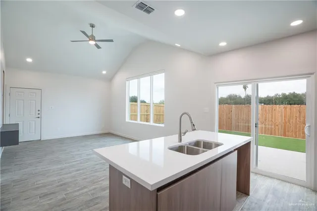 a kitchen with a sink and large window