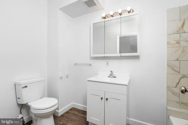 a bathroom with a sink toilet and mirror
