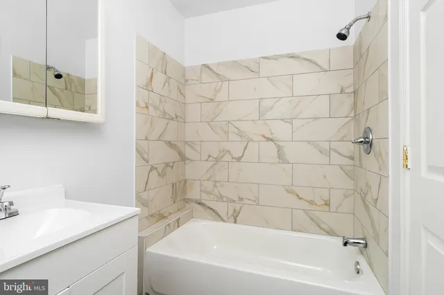 a bathroom with a bathtub and shower