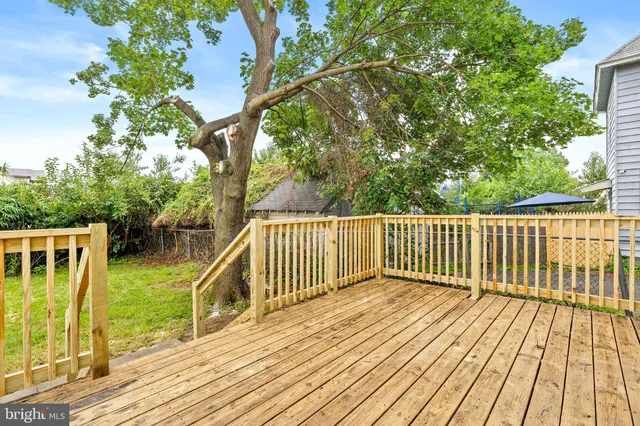 a view of balcony with wooden floor and fence