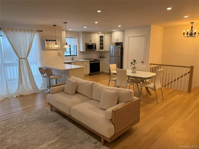 a living room with furniture and kitchen view