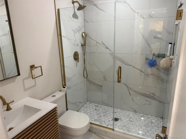 a bathroom with a shower toilet and sink