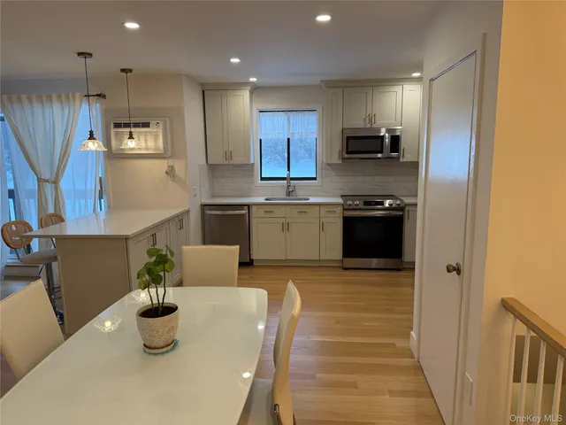 a kitchen with stainless steel appliances granite countertop a sink and a refrigerator