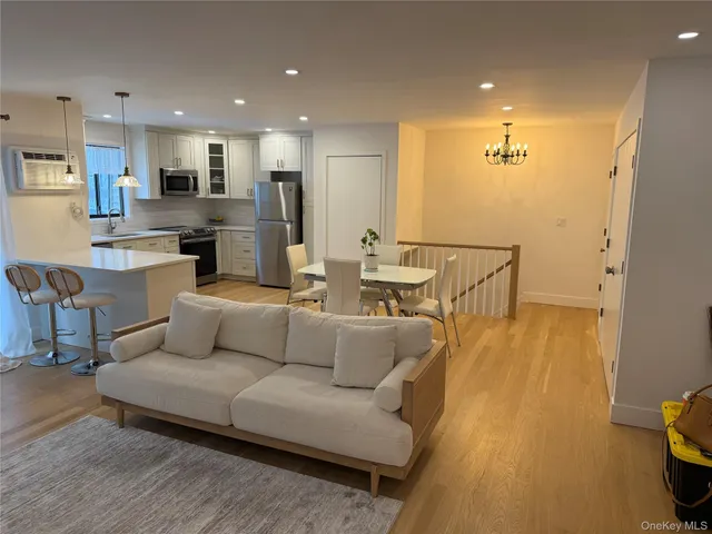 a living room with furniture and kitchen view