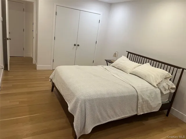 a bedroom with a bed and a night stand