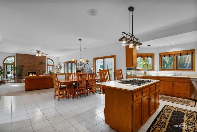 a kitchen that has a stove a table and chairs in it