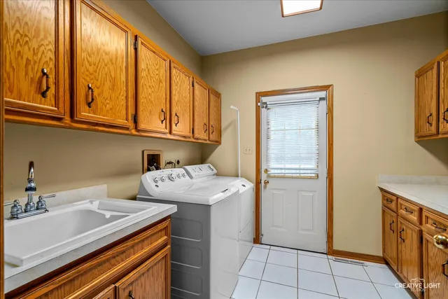 a utility room with a sink washer and dryer