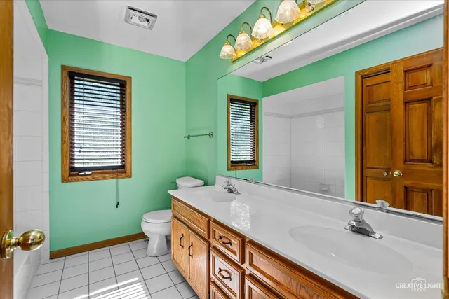 a bathroom with a sink mirror and a bathtub