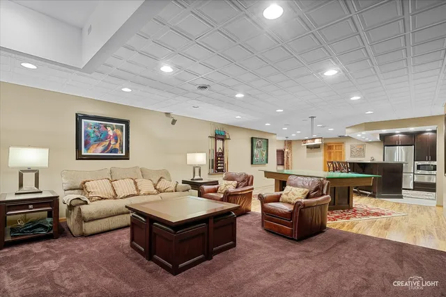 a living room with furniture and kitchen view