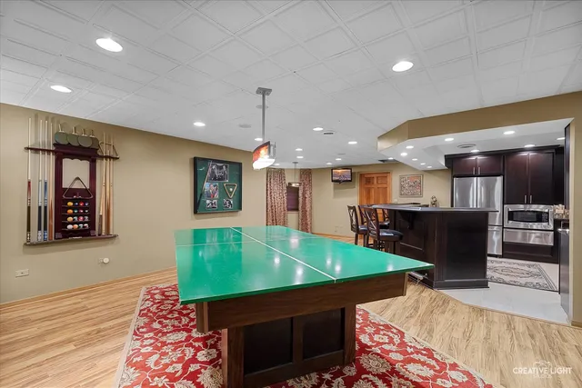 a kitchen with kitchen island a sink stove and wooden floor