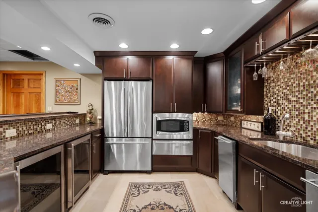 a kitchen with granite countertop stainless steel appliances and wooden cabinets