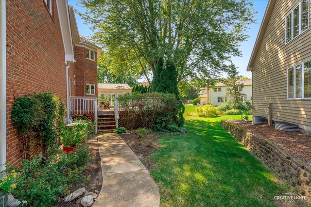 a backyard of a house with fountain and large trees
