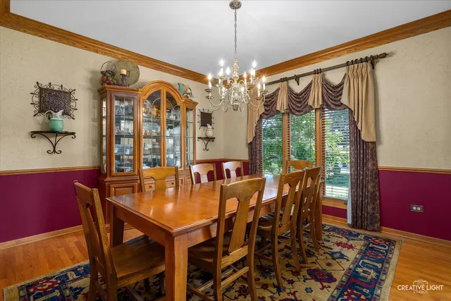 a view of a dining room with furniture and chandelier