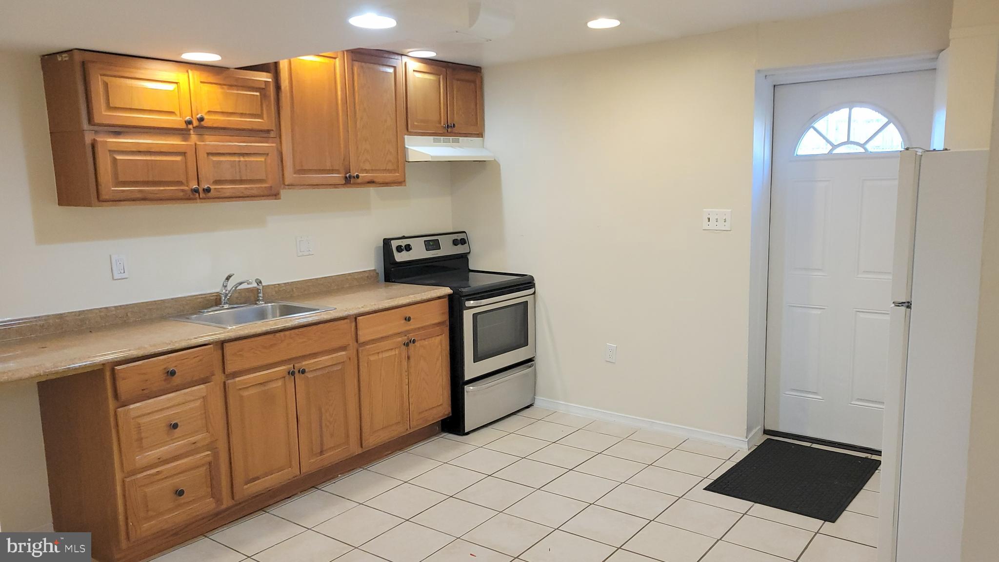 3217 Randall Road Suitland, MD 20746 - Photo 11 of 21 a kitchen with stainless steel appliances a sink stove and cabinets
