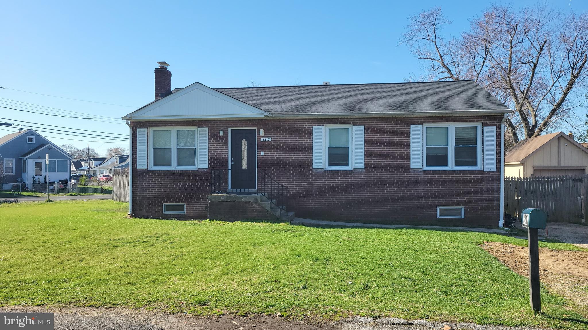 3217 Randall Road Suitland, MD 20746 - Photo 2 of 21 a front view of a house with a yard and garage