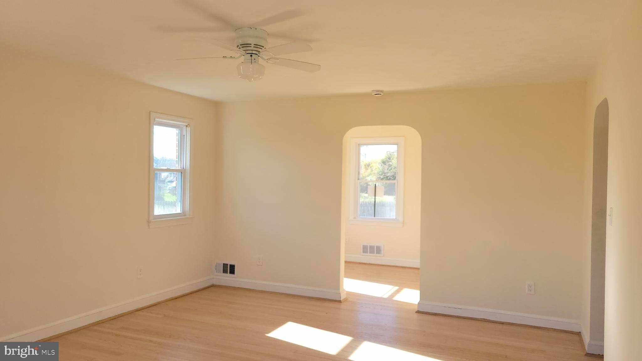 3217 Randall Road Suitland, MD 20746 - Photo 4 of 21 an empty room with wooden floor and windows