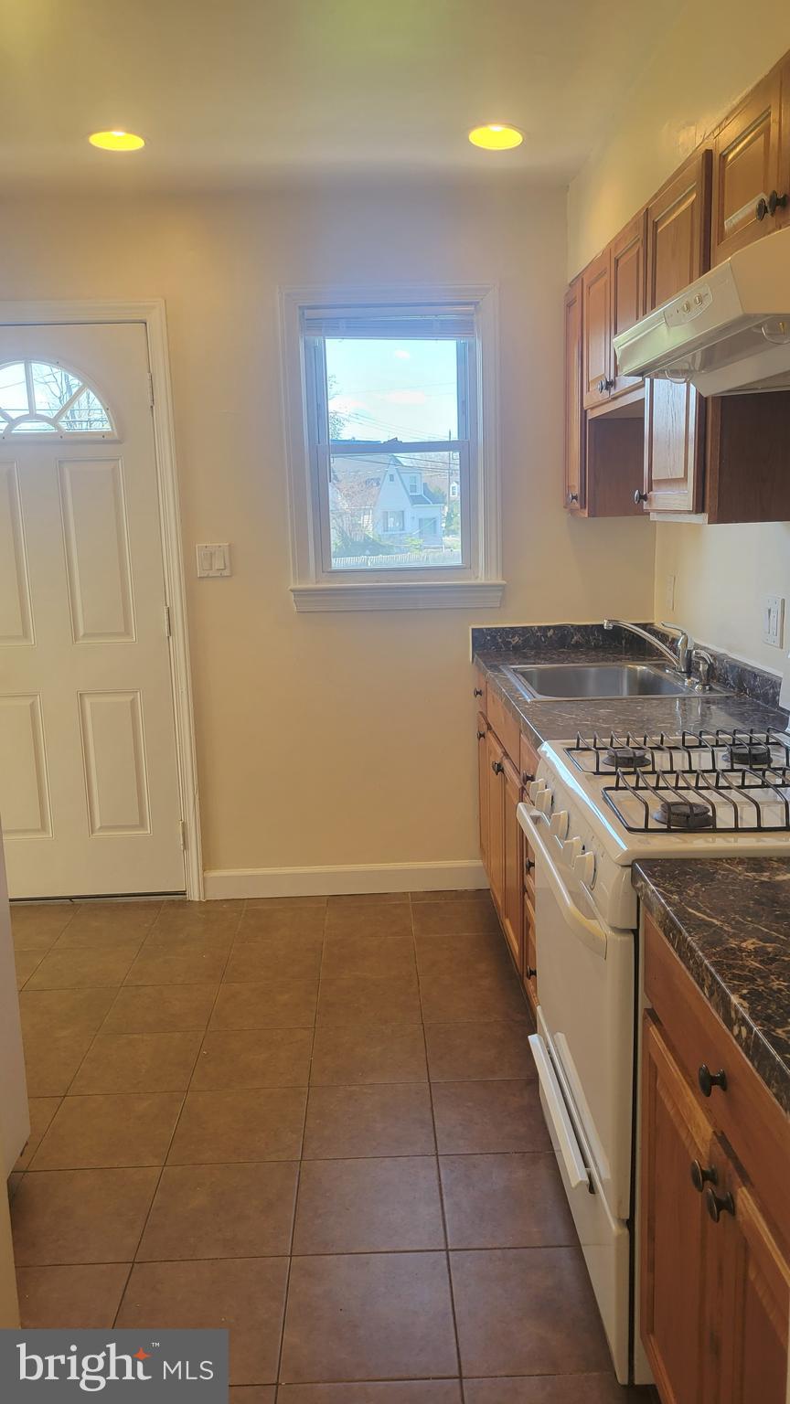3217 Randall Road Suitland, MD 20746 - Photo 5 of 21 a kitchen with a stove a sink and a microwave