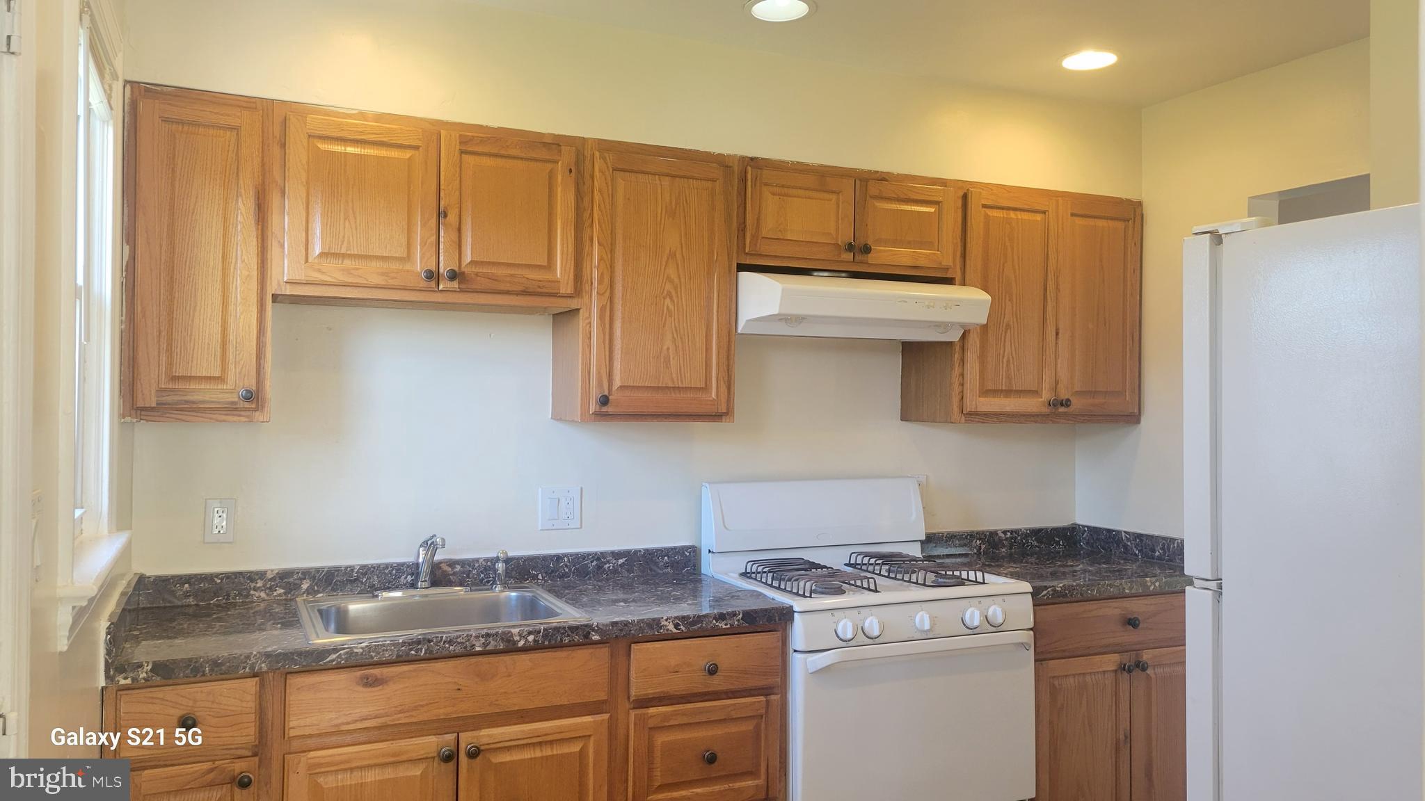 3217 Randall Road Suitland, MD 20746 - Photo 6 of 21 a kitchen with stainless steel appliances granite countertop a stove a refrigerator and a sink