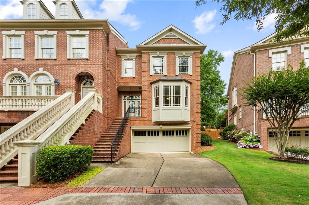 610 Timm Valley Road Northeast, Unit B Atlanta, GA 30305 - Photo 1 of 1 a front view of a house with a yard